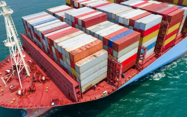 Cargo,Ship,Carrying,Container,Freight,And,Running,With,Tug,Boat